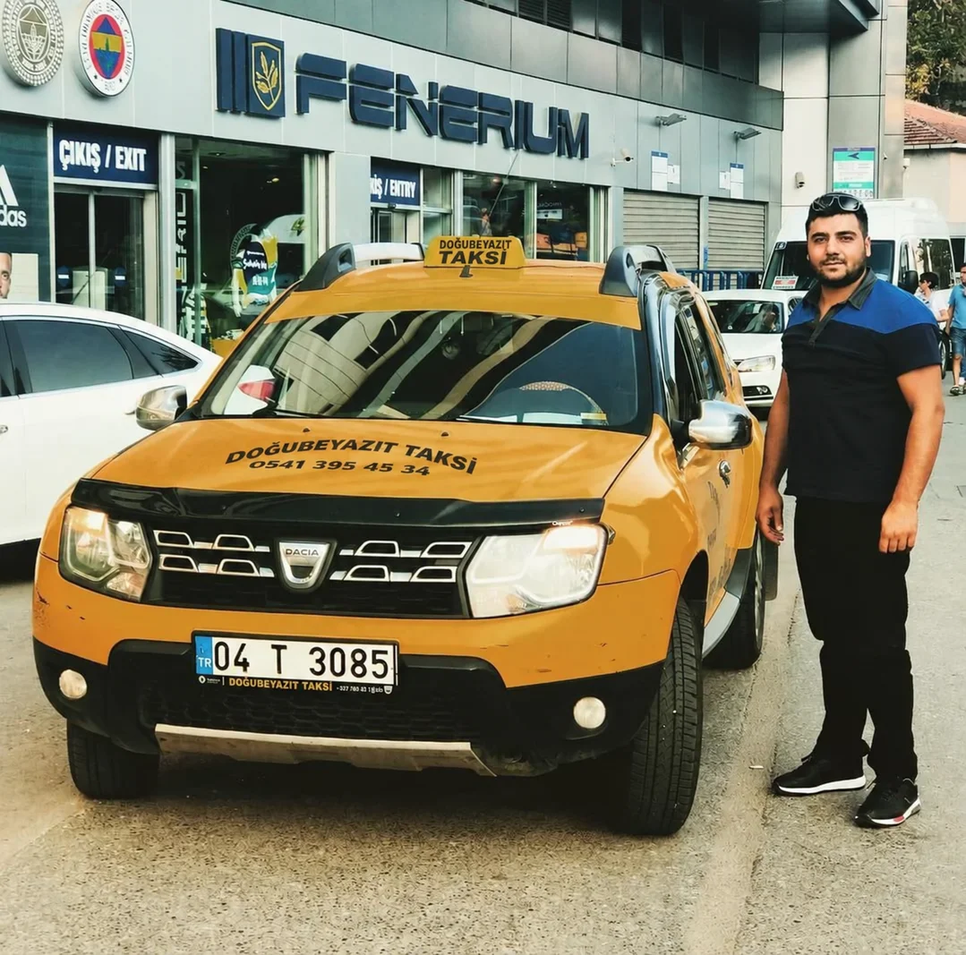 Doğubeyazıt Taksi şoförü sarı taksisinin yanında